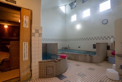 a bathroom with a large tub in a room at REKADO ROOM Kengun in Kumamoto