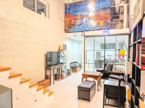 a living room with a staircase in a building at Comfort West Urban Chicago loft house in Chicago