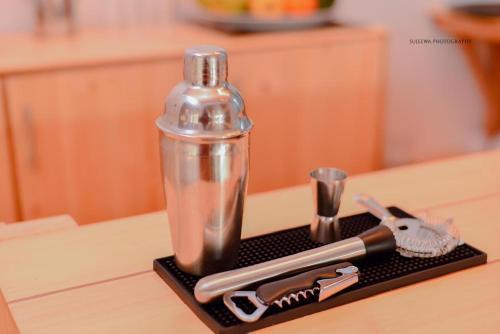 a black holder with a toothbrush and a bottle on a table at The Euro Lounge in Rambukkana