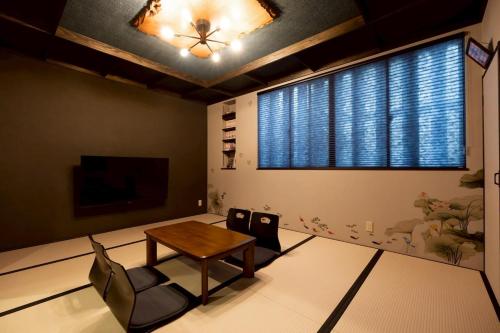 a living room with a table and two chairs at 旅宿信長と忍者---2階-忍者の間---NOBUNAGAtoNINJA in Omihachiman