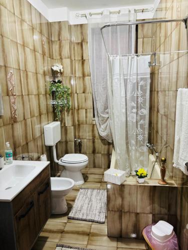a bathroom with a toilet and a shower and a sink at Casa Monteserrato in Terrasini