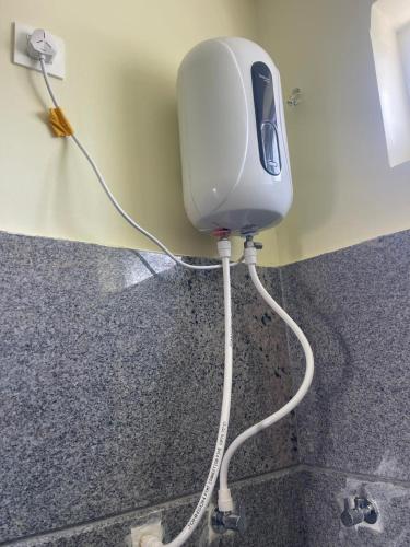 a blow dryer is plugged into a wall at Amaravathi Residency in Nārāyanavanam