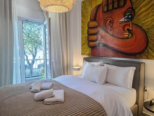 a bedroom with a large bed with two towels on it at Molly Downtown Thessaloniki in Thessaloniki