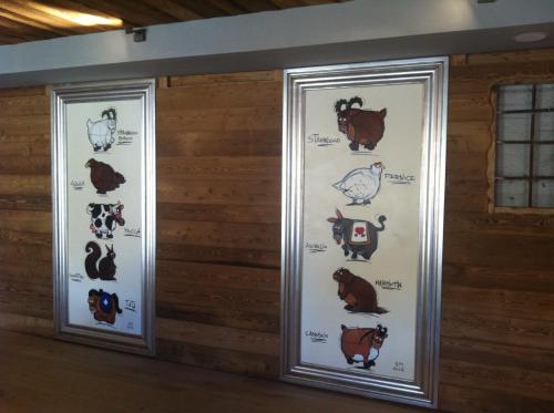two banners on a wall with different animals at Aux Pieds du Roi - Suite & Spa in Breuil-Cervinia