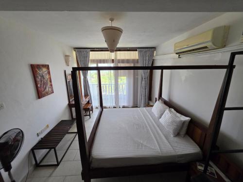a bedroom with a bunk bed and a window at Chic two bedroom Beachfront apartment 5th floor in Ukunda