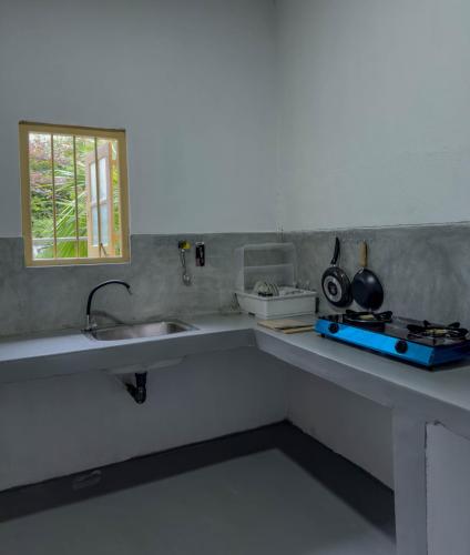 a kitchen with a sink and a counter top at Tidal Nest in Weligama