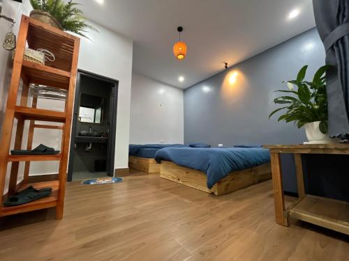 a bedroom with a bed and a wooden ladder at Shang Hotel in Uoc Le (1)