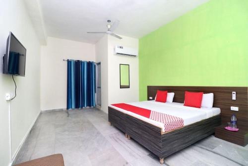 a bedroom with a bed and a flat screen tv at Hotel kashish in Waigaon