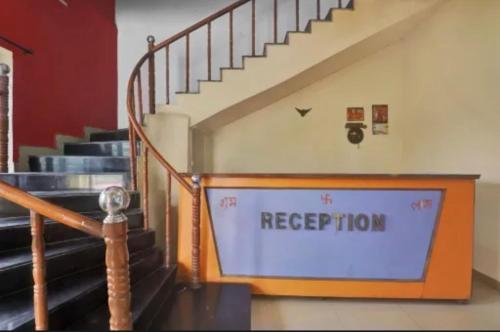 a staircase with a sign that reads reception at Hotel kashish in Waigaon