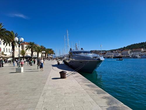 a boat docked at a pier next to the water at Villa mia Mirela in Makarska