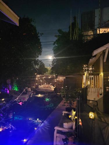 a view of a backyard at night with lights at Tranquility at the House of Alchemy Hollywood in Los Angeles