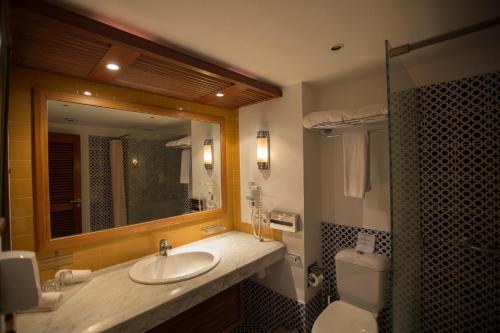 a bathroom with a sink and a toilet and a mirror at Lido Sharm Hotel Naama Bay in Sharm El Sheikh