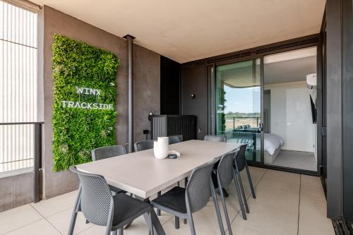 a dining room with a table and chairs at Winx Trackside Moonee Ponds in Moonee Ponds