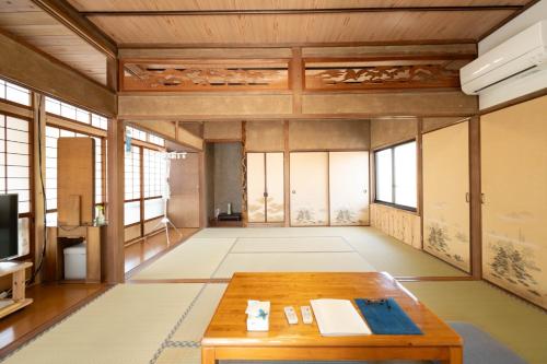 a living room with a table and some windows at Private accommodation Heki playground "Kawahara no - Vacation STAY 94708v in Furuichi