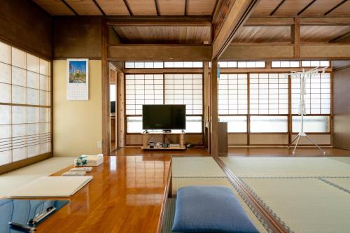 a living room with a tv and some windows at Private accommodation Heki playground "Kawahara no - Vacation STAY 94708v in Furuichi