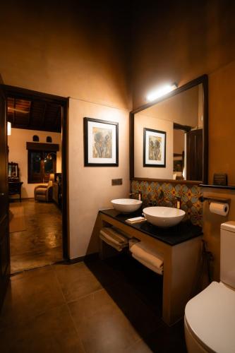 a bathroom with two sinks and a mirror at Kirindi Paddy Isle - Boutique Villa in Negombo