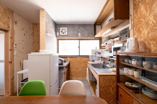 a kitchen with a refrigerator and a table and chairs at Private accommodation Heki playground "Kawahara no - Vacation STAY 94708v in Furuichi