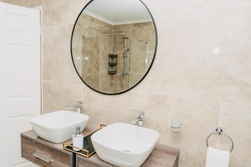 a bathroom with a sink and a mirror at Elle Residence in Gaborone