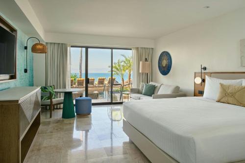 a bedroom with a bed and a view of the ocean at Marriott Puerto Vallarta Resort & Spa in Puerto Vallarta