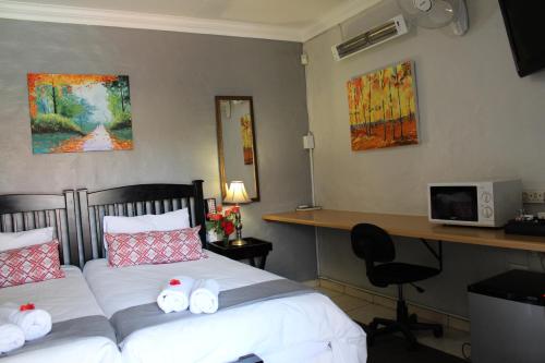 a bedroom with a bed with stuffed animals on it at 3 Liebeloft Guest House in Edenvale