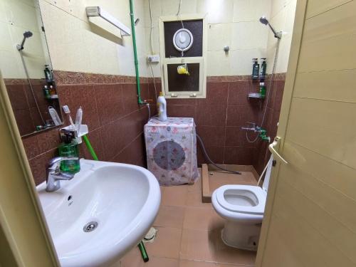 a bathroom with a sink and a toilet at Catchy & Traveler-Friendly Room in Dibba