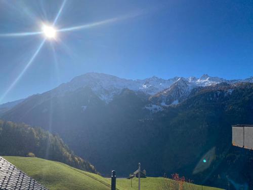 a view of a mountain with the sun in the sky at Chalet del Sole in Quinto
