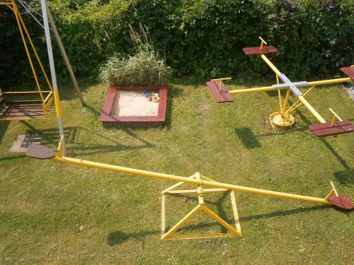 a group of childrens playground equipment on the grass at Pod Cisowcem in Sromowce Wyżne