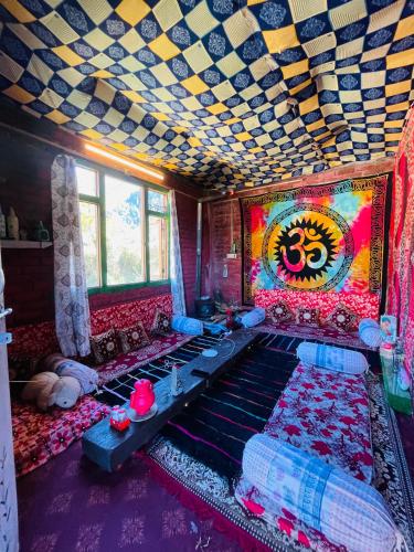 a room with a bed with a painting on the ceiling at Mj home in Kalgha