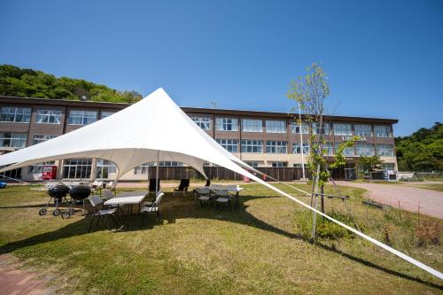 a large white tent in front of a building at KIBOTCHA/キボッチャ in Higashimatsushima
