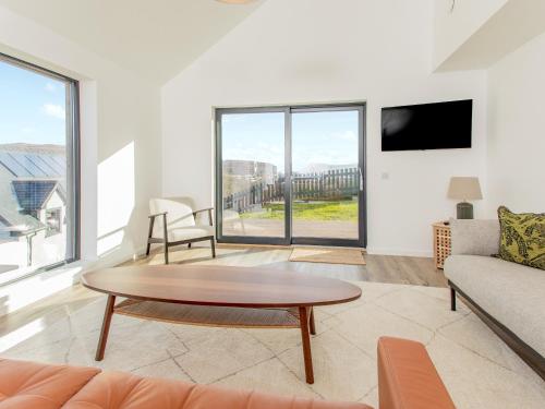 a living room with a table and a couch at Faodail in Portree