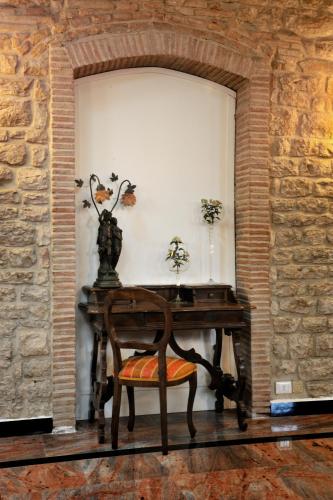 a wooden table with a chair and a desk at Hotel San Marco in Gubbio