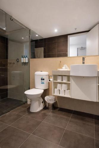 a bathroom with a toilet and a sink and a shower at Darwin Central Escape Hotel Style Apartment with Kitchen , Pool , Gym , Car Park,Balconey in Darwin