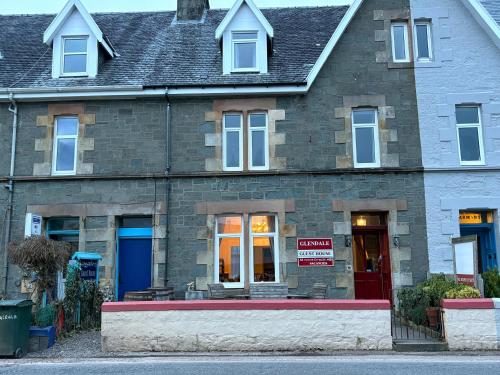 a brick building with a for sale sign in front of it at Glendale Guesthouse in Oban