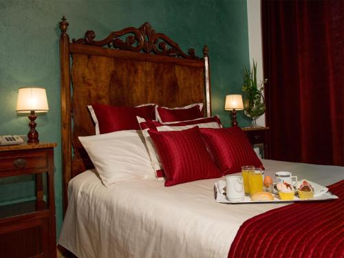 a bed with a tray of food on it at Hotel San Marco in Gubbio