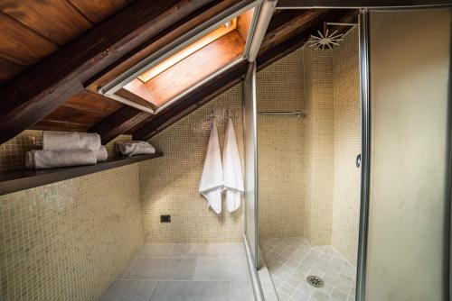 a shower with a glass door in a bathroom at Villa Almond in Taormina