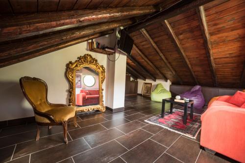 a living room with a red couch and a mirror at Villa Almond in Taormina