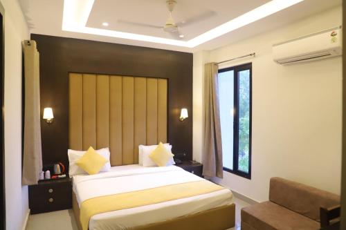 a bedroom with a large bed and a window at Hotel Grand Empire, Banquet, Swimming Pool with Taj View in Agra