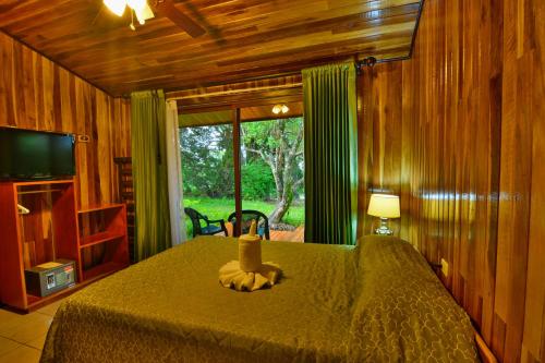 a bedroom with a bed and a large window at Mar Inn Costa Rica in Monteverde Costa Rica