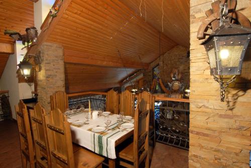 a dining room with a table in a building at Smerekova Hata in Yablunytsya