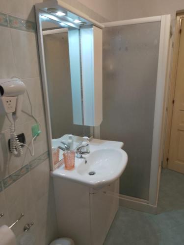 a bathroom with a sink and a shower with a mirror at B&B Donna Elvira in Siderno Marina