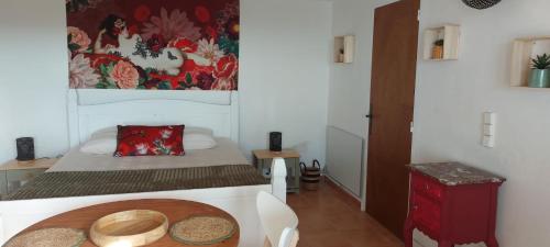 a small room with a bed and a table at CAP AZUR ILE du LEVANT in Île du Levant