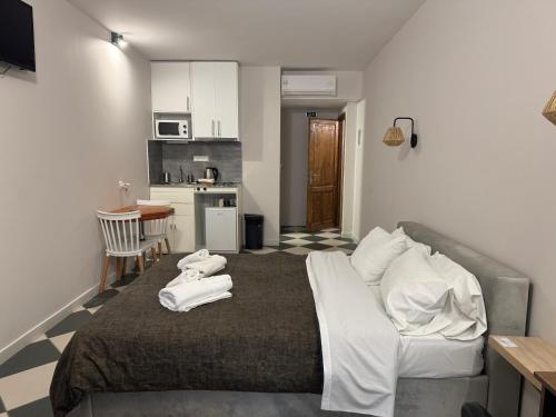 a bedroom with a large bed with towels on it at Casa Tua in Kalamata