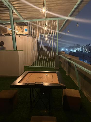 a table on the roof of a building with lights at Staywise in Indore