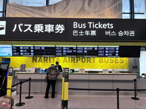 a man standing at an airport check in counter at GJbb 小岩駅から徒歩6分 羽田空港成田空港行きの直行バス 子連れ in Tokyo