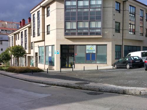 a large building on the corner of a street at Albergue Turistico la Credencial in Santiago de Compostela