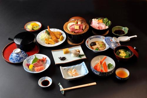 a table with many plates of food on it at Nakayasu Ryokan in Kanazawa