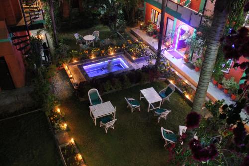 an overhead view of a patio with chairs and a pool at New Pokhara Lodge - Pokhara Lakeside in Pokhara