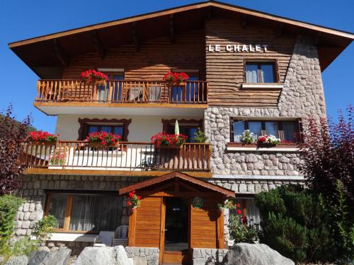 a building with flowers on the balconies of it at Le Chalet in Les Deux Alpes