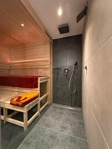 a bathroom with a shower and a bed in it at VizslaVilla in Poroszló