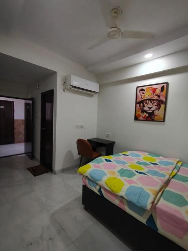 a bedroom with a bed with a colorful comforter at Staywise in Indore